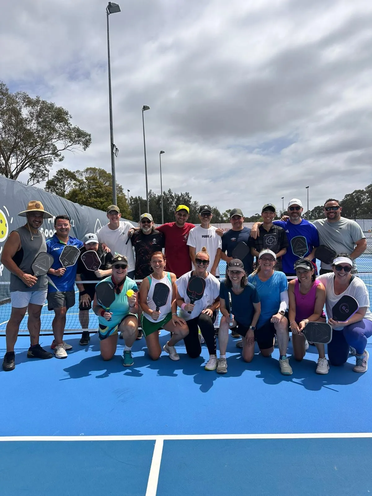 A large league group photo on an outdoor court